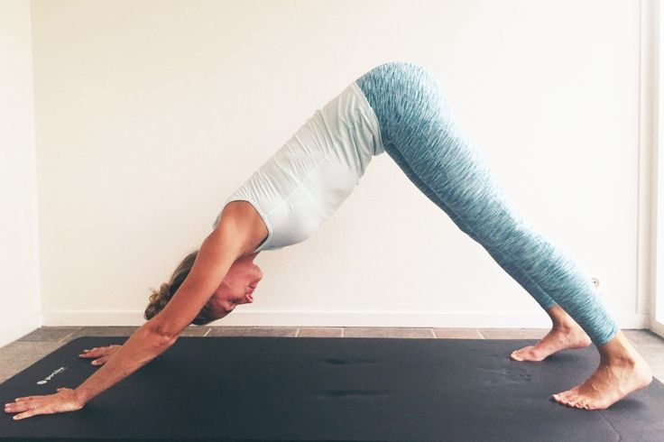 a woman is doing yoga on a mat