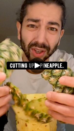 a man is holding up pineapples with the words cutting up pineapple in front of him