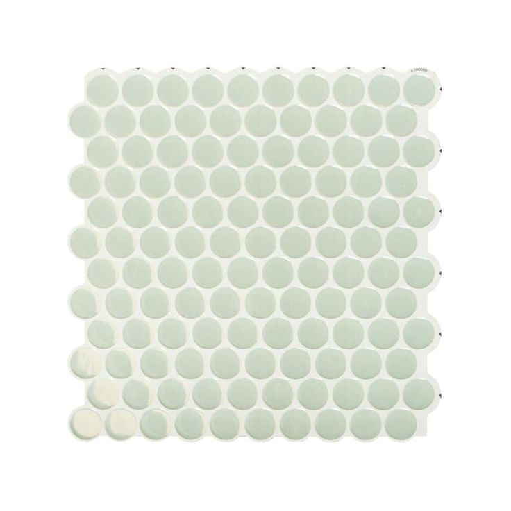 the back side of a white tile with circles on it and dots in the middle