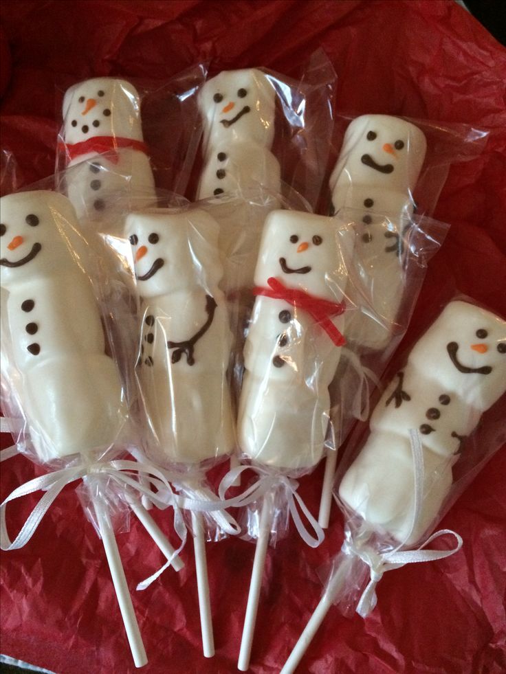 marshmallows wrapped in cellophane and decorated like snowmen