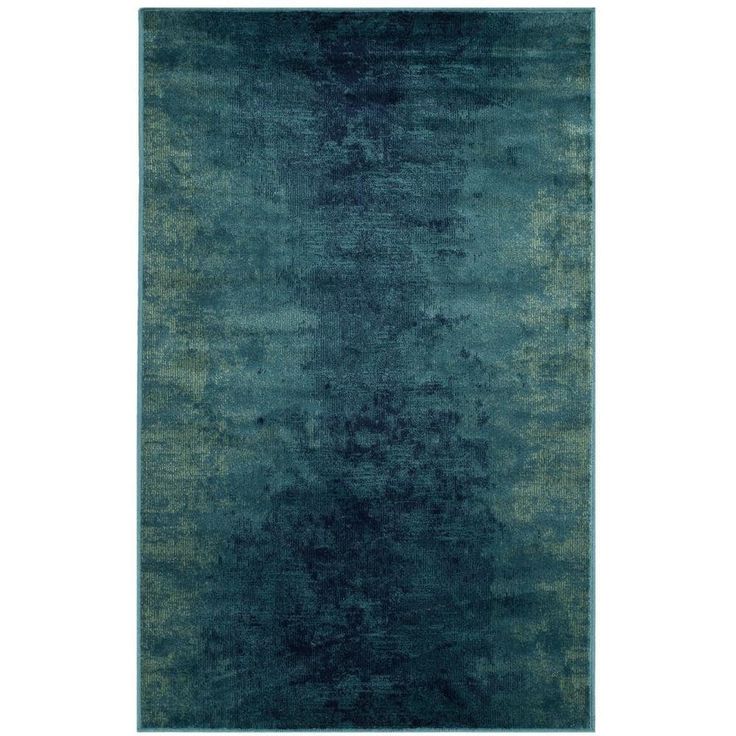 an area rug with dark blue and green colors on the carpet, it is very soft