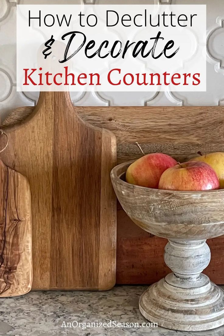 a wooden bowl filled with apples on top of a counter