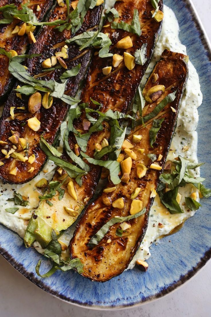 grilled eggplant, avocado and spinach on top of mashed potatoes