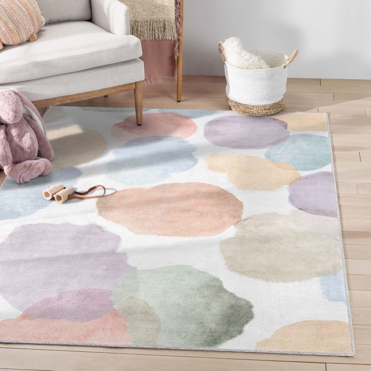 a living room area with a rug, chair and teddy bear on the floor in front of it