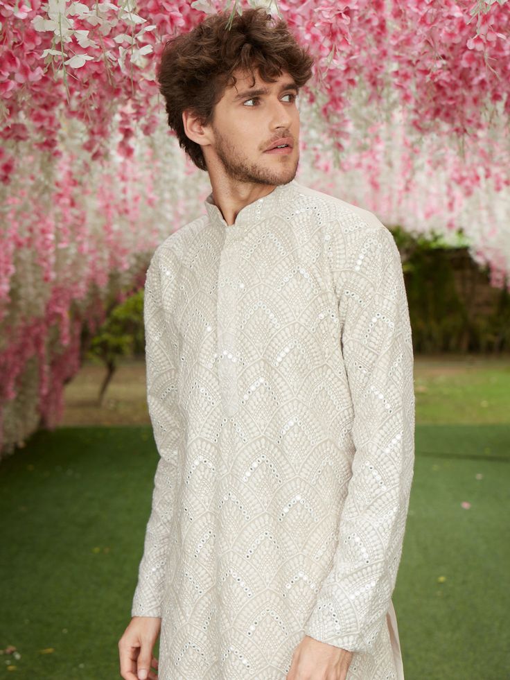 SHRESTHA BY VASTRAMAY Men's Gray Ethnic Mirror Kurta An elegant ethnic mirror kurta that embodies traditional charm and contemporary style. Perfect for special occasions and cultural celebrations, this gray kurta is designed to make a statement. Key Features: Color: Gray Design: Ethnic Mirror Work Occasion: Festive, Ethnic Wear Specifications: Fabric: Cotton Sleeve Type: Full Sleeves Neck: Mandarin Collar Fit: Regular Fit Material & Care: This kurta is made from high-quality cotton fabric. To ma Festive Bandhgala With Zari Work In Traditional Fit, Festive Bandhgala With Zari Work, Festive Chikankari Embroidery Bandhgala For Eid, Traditional Fit Bandhgala With Chikankari Embroidery For Festive Occasions, Traditional Fit Bollywood Bandhgala For Eid, Festive Bandhgala With Cutdana Details, Bollywood Style Ceremonial Sherwani With Traditional Fit, Eid Bandhgala With Cutdana In Traditional Fit, Ceremonial Straight Kurta With Mirror Work