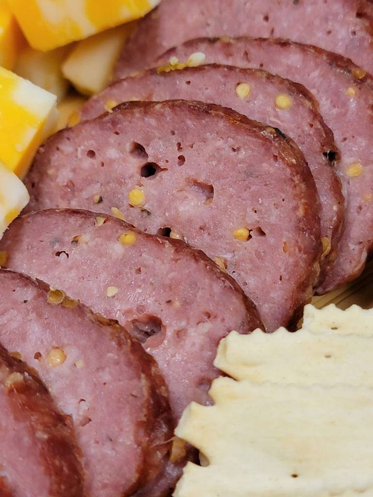 ham and cheese on a plate with text overlay that reads summer sausage easy recipe and no casing required