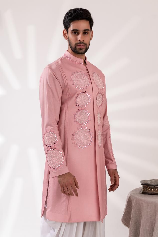 Pink long sleeves kurta with flora mirror embroidery and pintucked panel on shoulders. Paired with white cowl pant.
Components: 2
Pattern: Embroidered
Type Of Work: Mirror Flora
Neckline: Mandarin Collar
Sleeve Type: Long
Fabric: Chanderi Silk, Modal Satin
Color: Pink, White
Other Details: 
Approx weight: 2kgs
Cotton lining
Occasion: Mehendi and Puja, Sangeet - Aza Fashions Mirror Embroidery, Satin Color, Embroidered Silk, Mandarin Collar, Aza Fashion, Sleeve Type, Pink White, Mens Pants, Types Of Sleeves