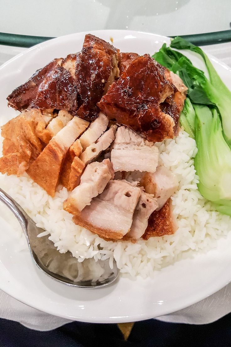 a white plate topped with rice and meat