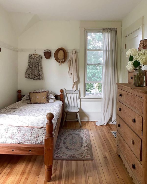 a bedroom with wooden floors and white walls