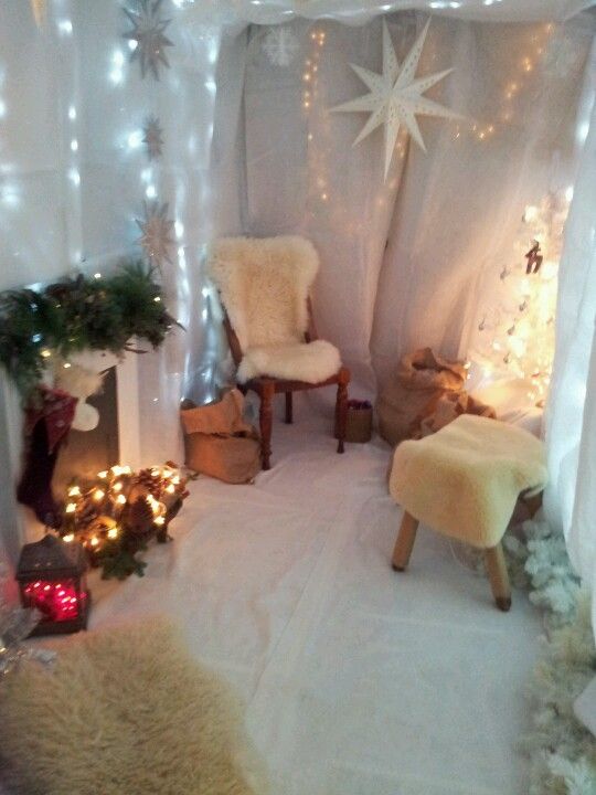 a room decorated for christmas with lights and decorations