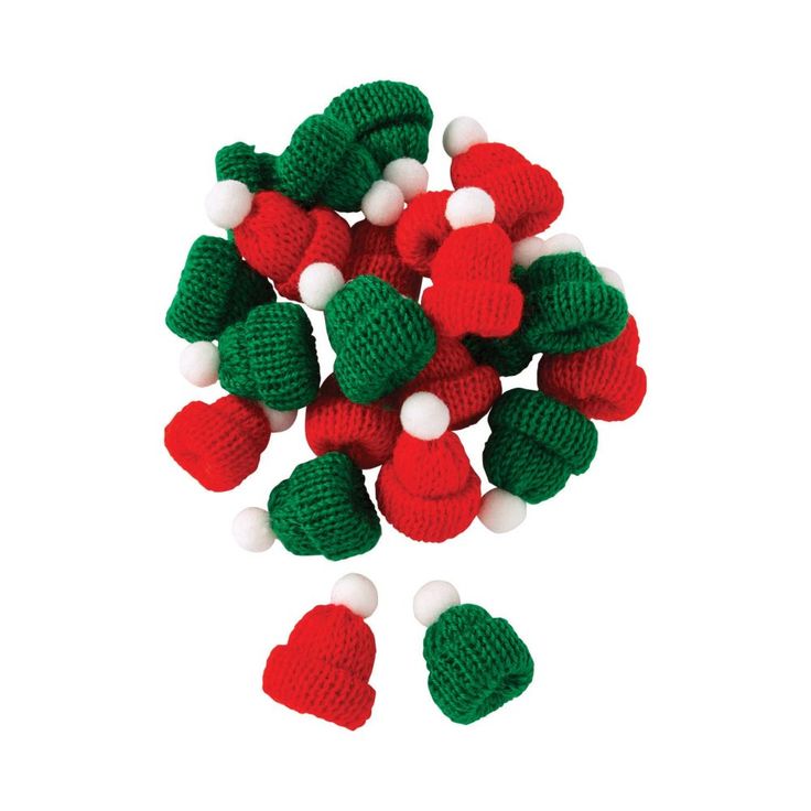 small knitted christmas decorations with green and red pom - poms on white background