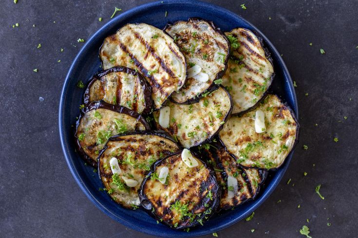 grilled eggplant slices in a blue bowl