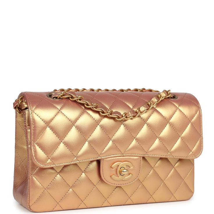 This Chanel small double flap bag is in gold iridescent metallic calfskin leather with antique gold tone hardware and features a front flap with CC turnlock closure, back half moon pocket and adjustable interwoven anitque gold chain link shoulder/crossbody strap.The interior is lined in gold metallic leather with the "love letter" zipper compartment under the first flap, an "outer" slit pocket under the second flap, and an interior compartment with two open pockets separated by a "lipstick" compartment.Collection: 2021 (RFID)Origin: FranceCondition: New and never (plastic on hardware) - one tiny scuff to into pocket.Accompanied by: Chanel Box, Chanel dustbag, carebook, RFIDMeasurements: 9" width x 5.25" height x 2.5" depth; 16.5" strap drop (9.5" doubled) Chanel Box, Chanel Bags, Metallic Leather, Flap Bag, Prada Bag, Half Moon, Crossbody Strap, Chanel Classic, Antique Gold