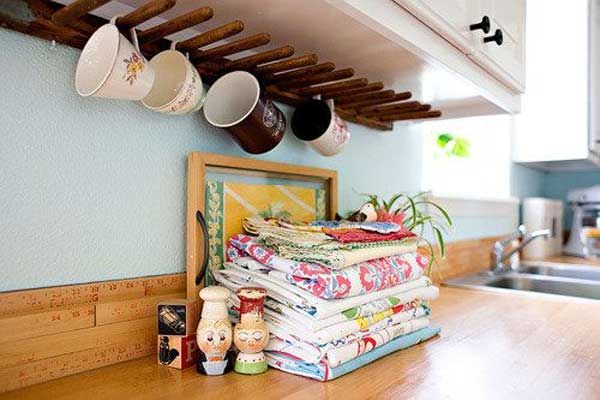 the kitchen has many pots and pans hanging from the ceiling