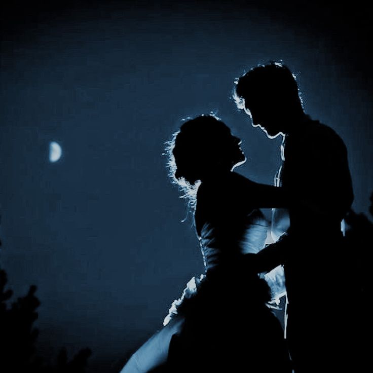 a man and woman dance in the dark at night with moonlight behind them, as well as a half moon