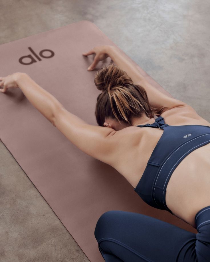 a woman is doing yoga on a mat