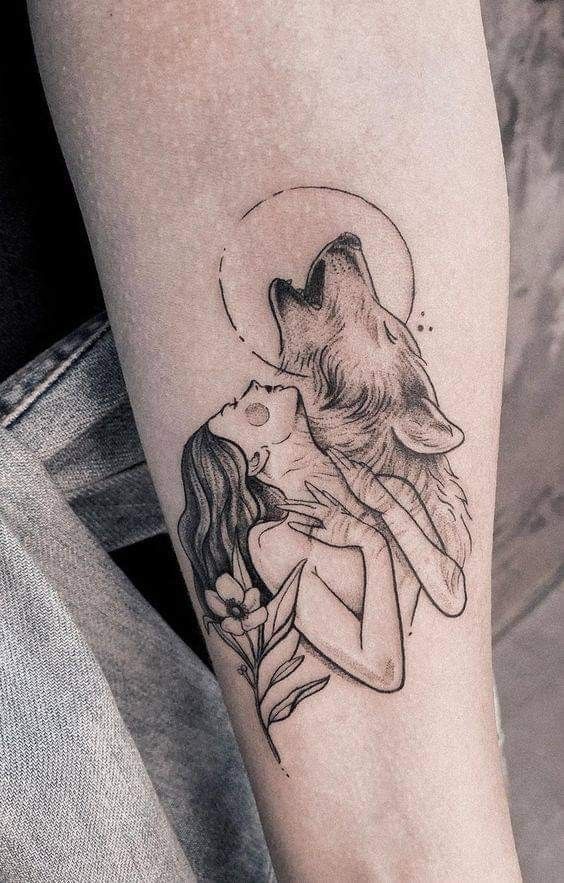 a woman with a wolf tattoo on her arm and the words, i love you