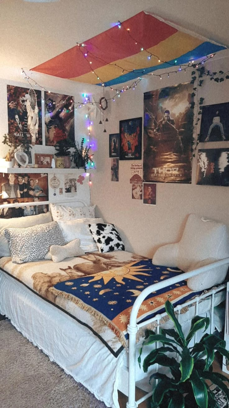 a bed room with a neatly made bed and lots of pictures on the wall above it