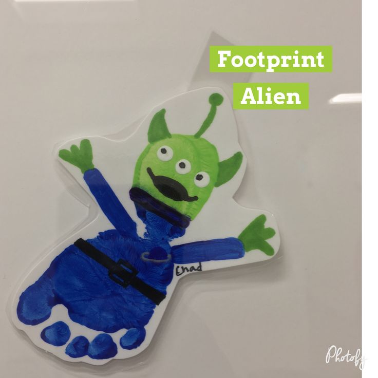 a paper cut out of an alien with the words footprint alien written on it