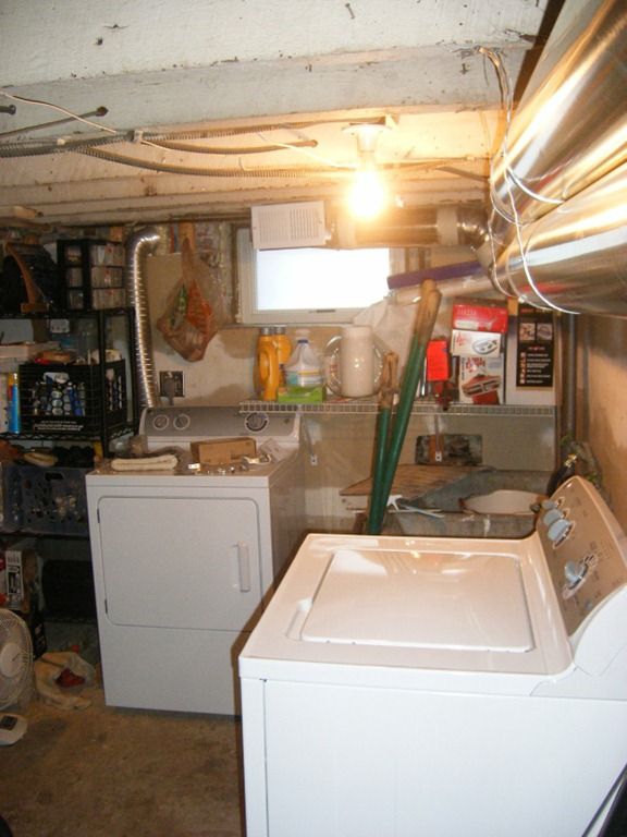 a kitchen with a washer, dryer and other items in the room next to it