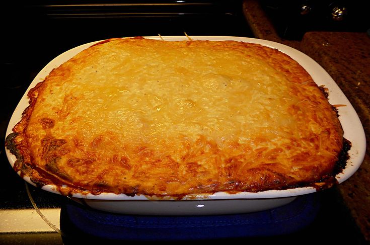 a casserole dish sitting on top of a blue and white plate in the kitchen