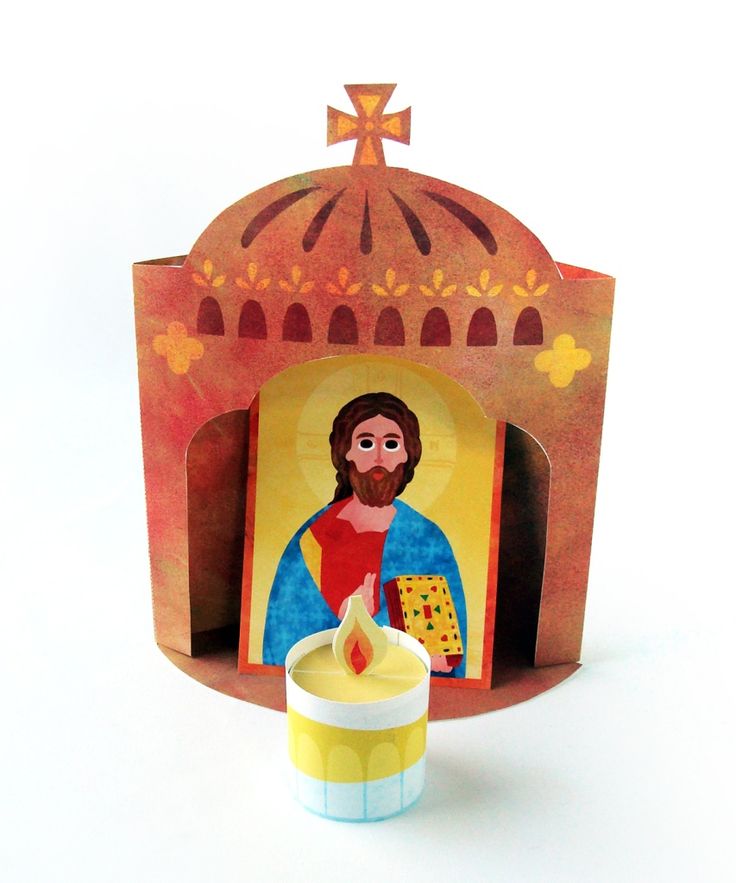 a paper cutout of jesus holding a lit candle in front of a small shrine