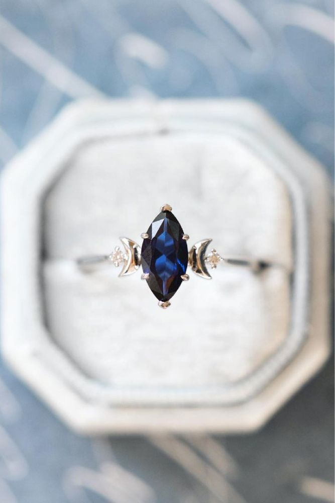 an engagement ring with a blue stone in it