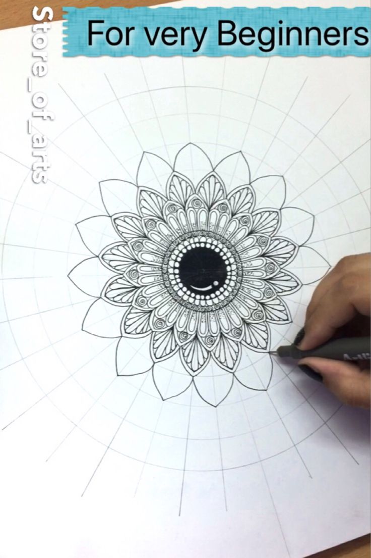 someone is drawing a flower on paper