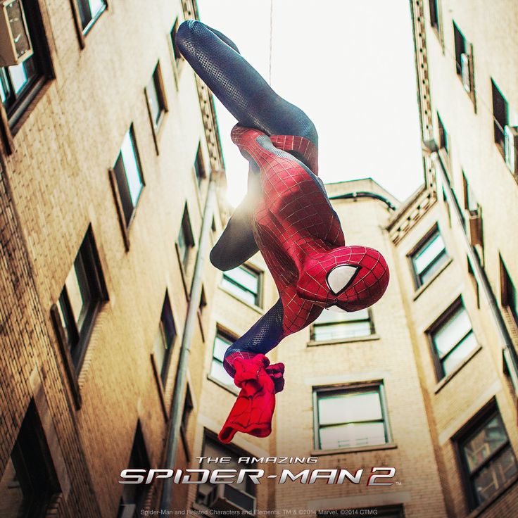 the amazing spider - man 2 movie poster is hanging in front of a tall building