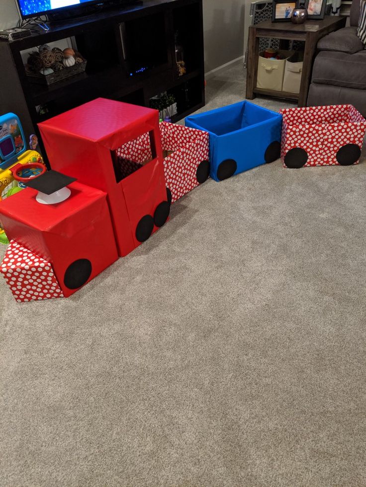 a child's playroom with toys in the shape of train cars