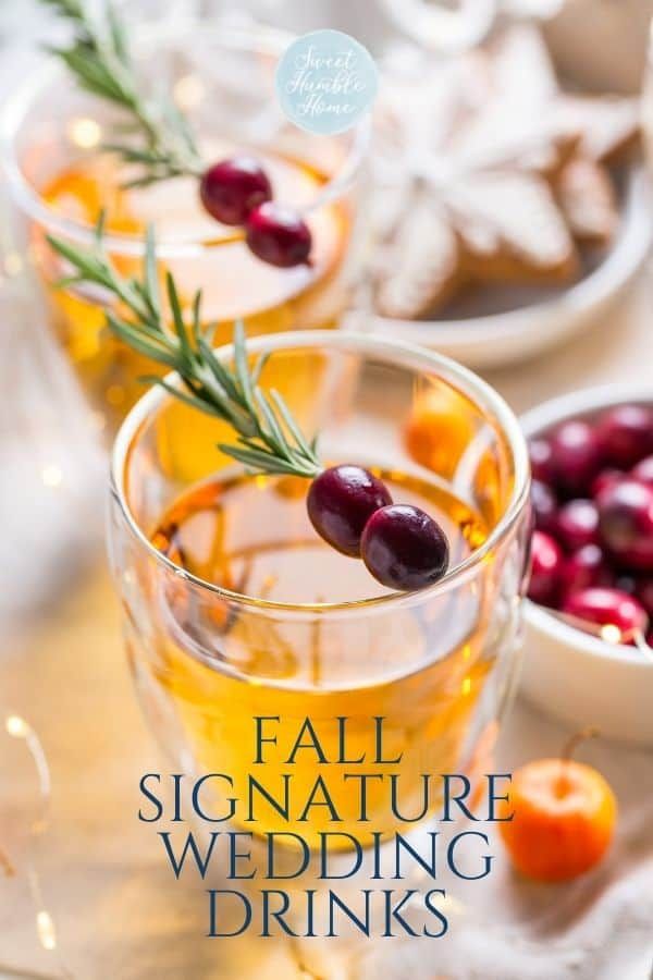 fall signature wedding drinks with rosemary garnish and cranberries in the background