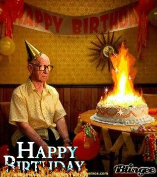 an older man sitting in front of a birthday cake with the words happy birthday on it