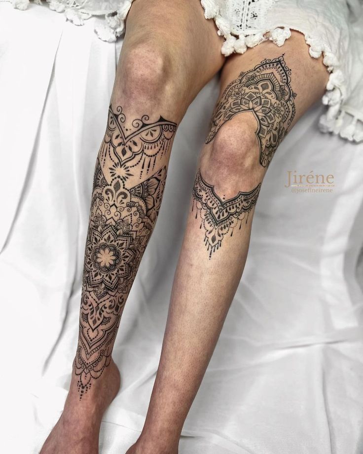 the legs and ankles of a woman with tattoos on her feet are covered in lace