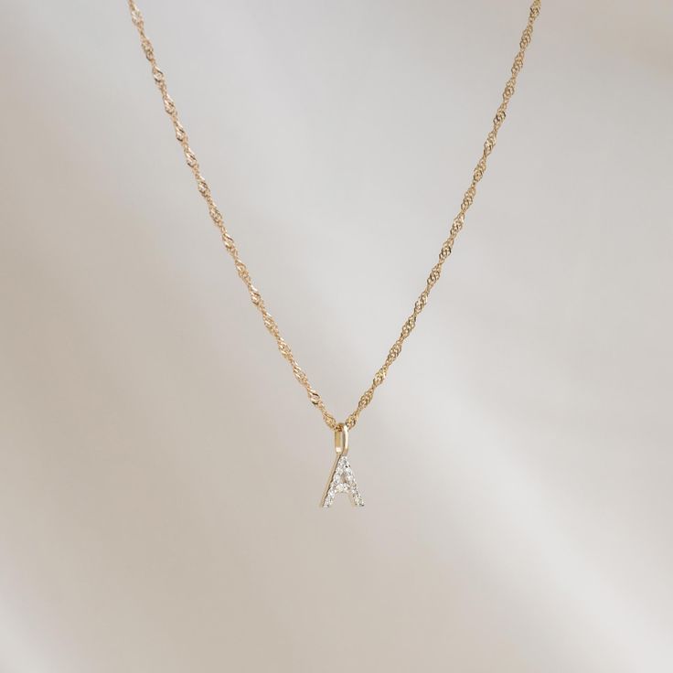 Crafted from 14k gold, this exquisite Singapore chain necklace features a twist design that catches the light with every movement.

Necklace has an adjustable length and can be worn at 16”, 17”, and 18”. Elegant 14k Gold Charm Necklace With Figaro Chain, Yellow Gold Figaro Chain Necklace With Initial Pendant, Elegant 14k Gold-filled Necklace With Figaro Chain, White Gold Initial Necklace With Cable Chain, Elegant 14k Gold-filled Initial Pendant Charm Necklaces, Elegant 14k Gold-filled Charm Necklaces With Initial Pendant, Elegant Everyday Name Necklace With Cable Chain, Gold Jewelry With Adjustable Chain And Modern Twist, Minimalist Necklace With Initial Pendant On Gold Chain