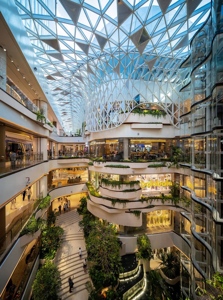 the inside of a shopping mall with lots of plants