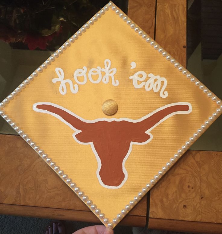 a decorated graduation cap with the word, heifer team on it and an image of a longhorn's head