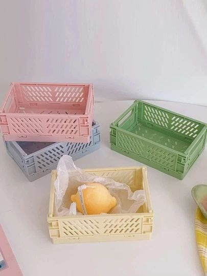 four plastic baskets sitting on top of a white table next to watermelon slices