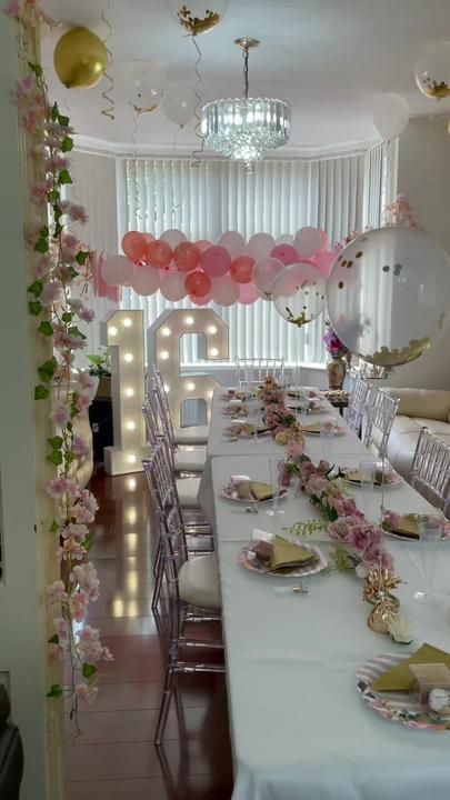 a long table with balloons and plates on it