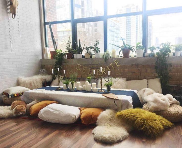 a room filled with lots of plants and stuffed animals on top of wooden flooring