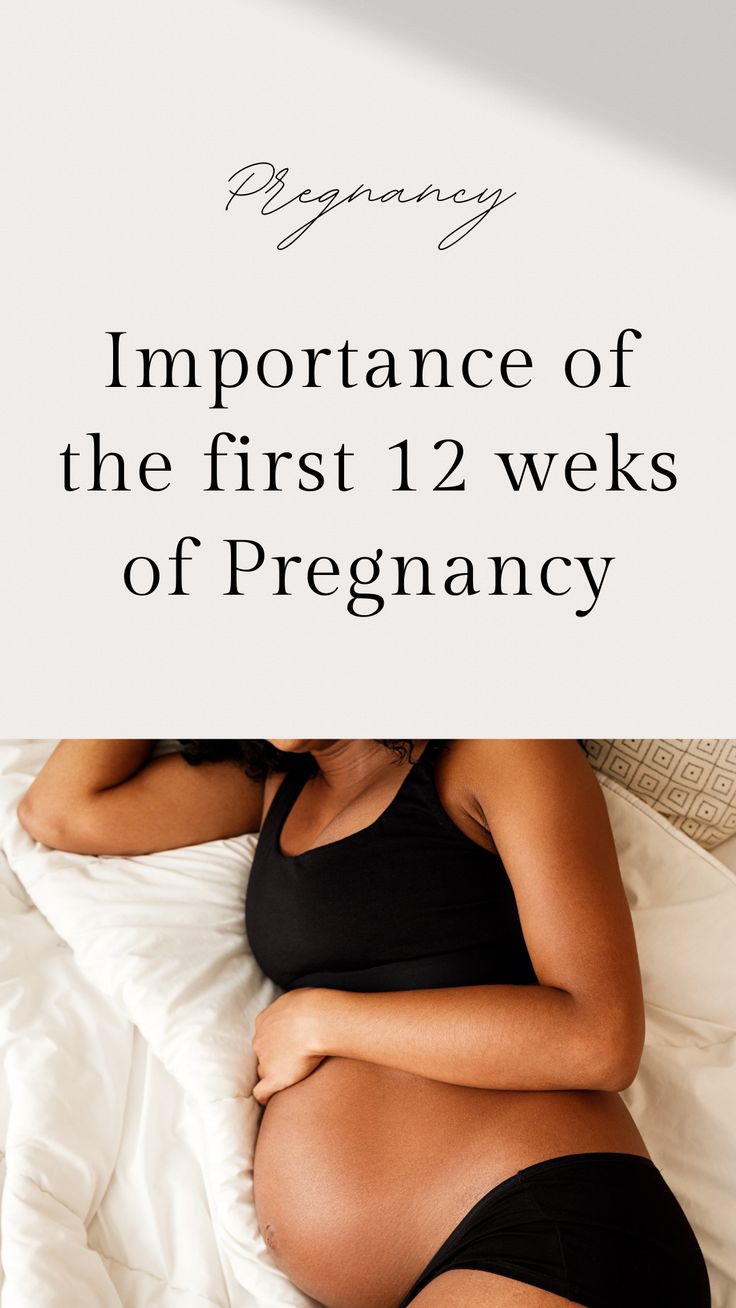 the pregnant woman is laying in bed with her stomach exposed