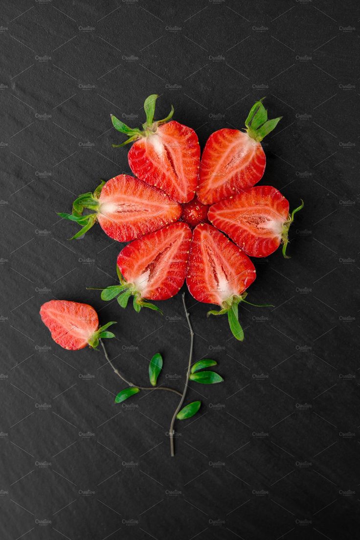 strawberries with leaves on black background