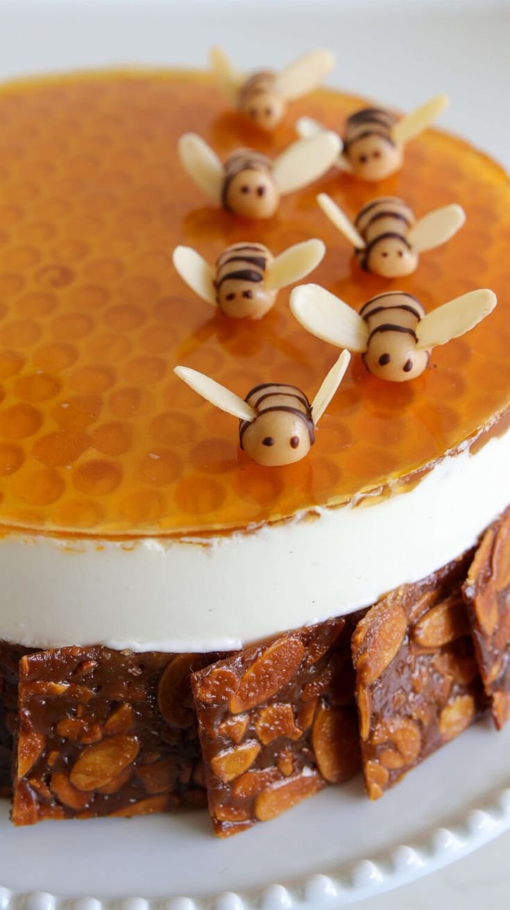 there is a cake that has been decorated with honeycombs and bees on top