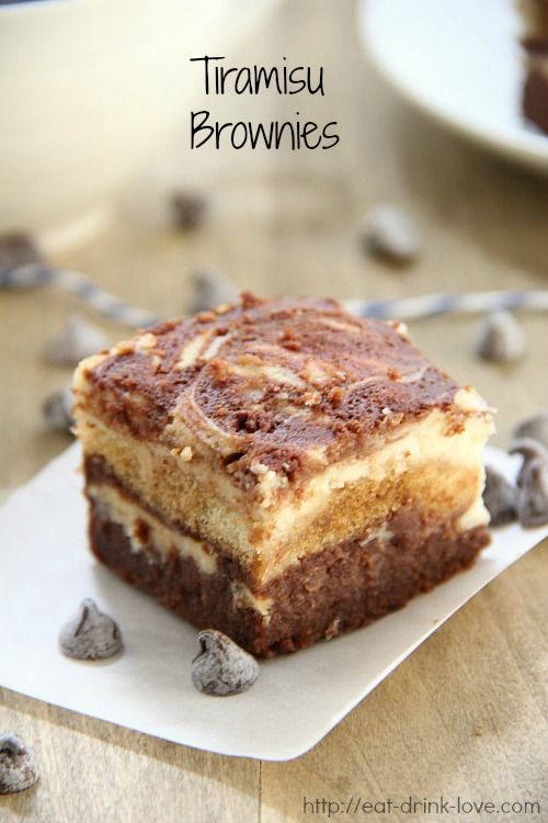 a piece of cake sitting on top of a white plate with chocolate chips around it