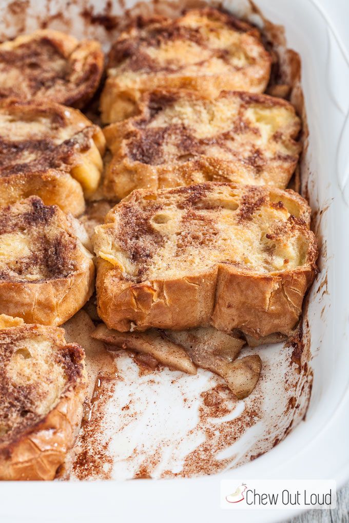 some food is in a white dish on a table and it looks like cinnamon rolls