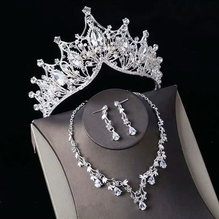 a tiara and earrings are on display