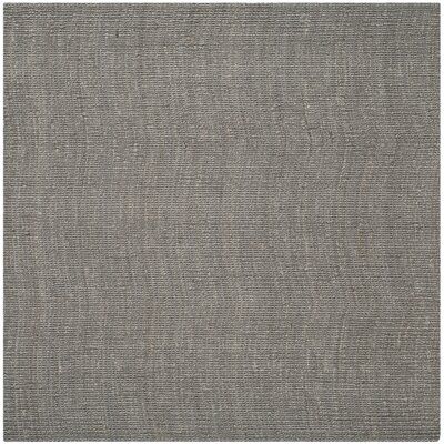 a gray rug with an uneven design