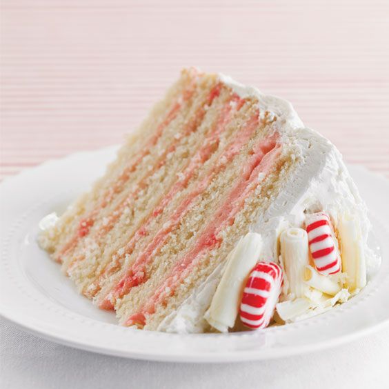 a slice of cake with white frosting and candy canes