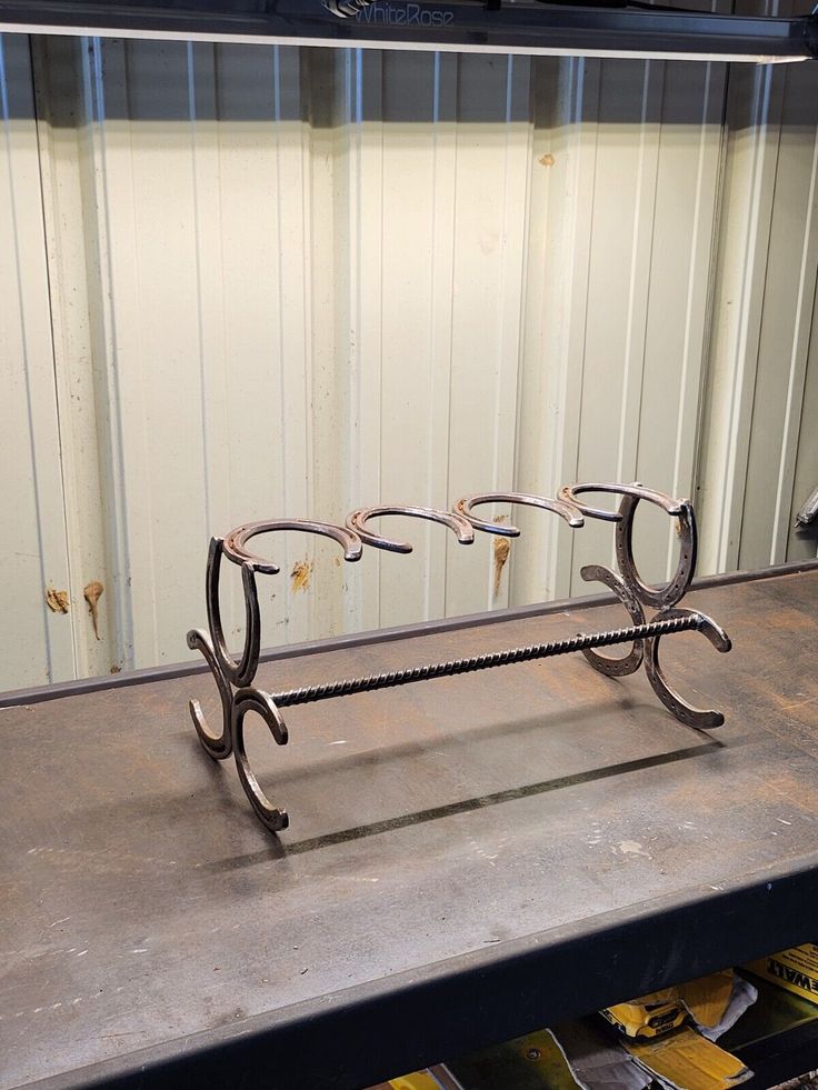 a pair of glasses sitting on top of a metal bench