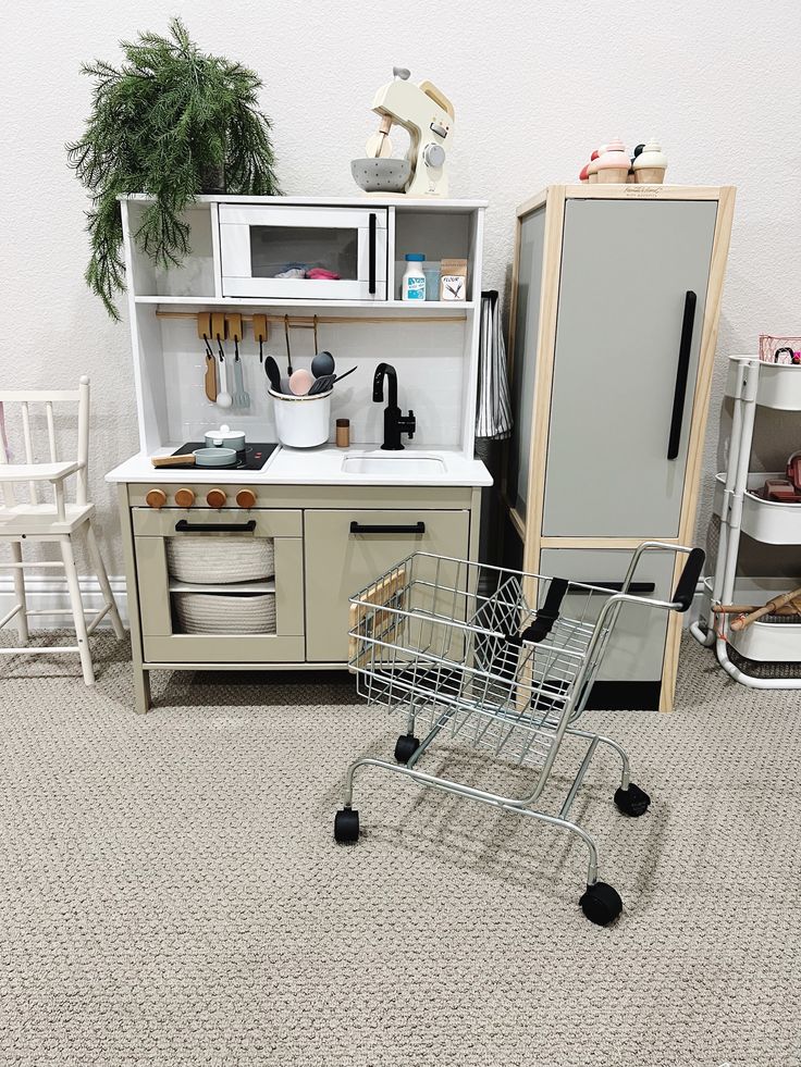 a shopping cart sitting in the middle of a kitchen floor next to an oven and microwave