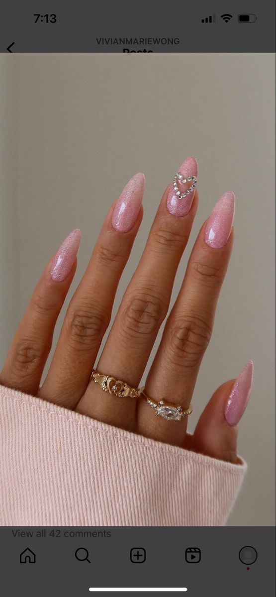 Pink glitter almond shaped nails with bedazzled heart jewels Pink Heart Rhinestone Nails, Blush Pink Nails Prom, Bday Pink Nails, Pink Nails With Jewels Rhinestones, Pink Nails Acrylic Birthday, Pink Glitter Nails With Gems, Long Nail Designs Pink Glitter, Pink Nail Ideas Almond Shape, Pink Nails Jewels